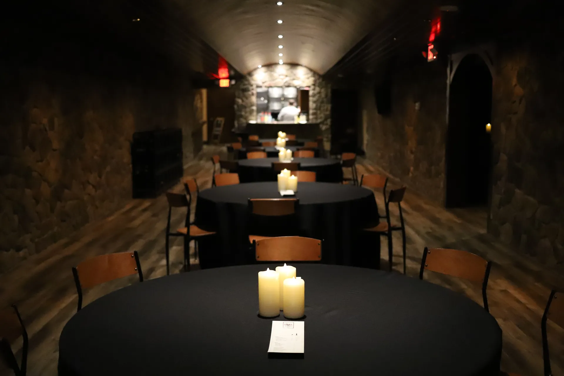 Bella Vino event room with stone walls and candle-lit tables